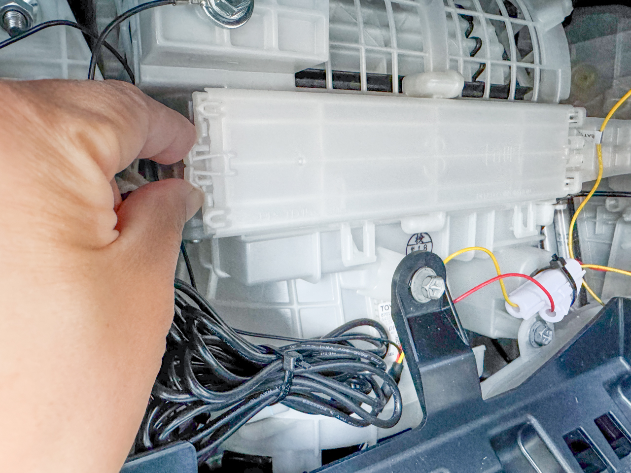 フィルターカバーのツメをつまんでいる様子